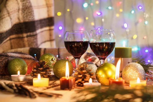 Two glasses of wine in the New Year decorations. Christmas background. New Year\'s lights