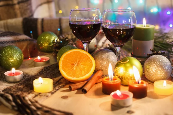 Two glasses of wine in the New Year decorations. Christmas background. New Year\'s lights