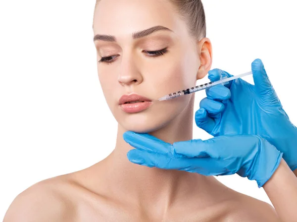 在嘴唇附近注射的女人。 整形手术 免版税图库照片
