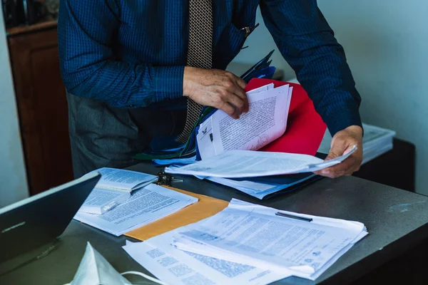 lawyer, office worker searching a document and reading important documents for his job.