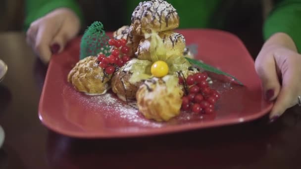 美味可口的奶油泡芙慕斯奶油布丁糕点蛋糕甜点与草莓放在正方形红盘上的近景 — 图库视频影像
