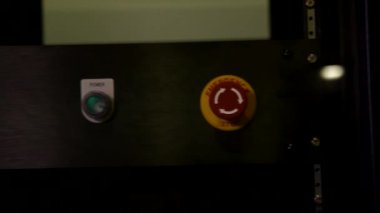 İnsan eli dijitale basıyor. Başlatma gücü acil durum düğmesi düğmesi. Metal çelik makine konsolu.