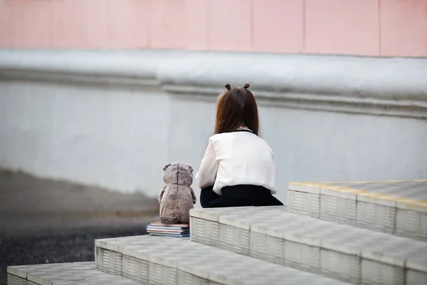 Girl sitting with her back — Stock Photo, Image