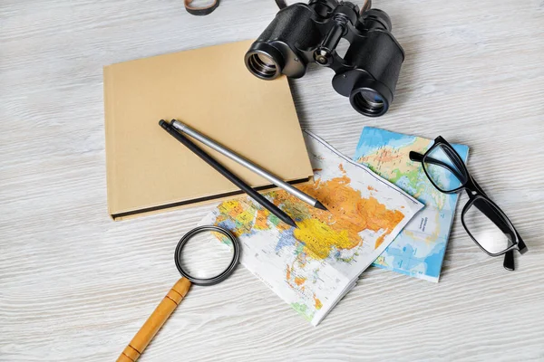 Travel plan background. Ready for the trip. Map, book, magnifier, binocular, pencils and glasses.