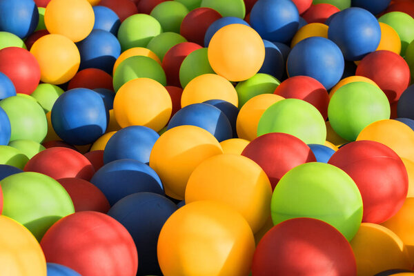 background of a pool of plastic balls of bright different colors