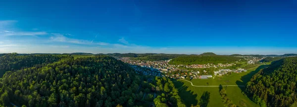 Inspirational aerial landscape, summer green forest and a lovely town in a valley at the recreation aera of the Swabian Alb in germany