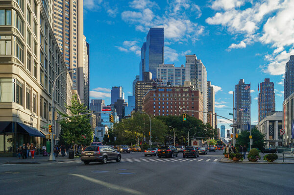 Street view of New York, US, from low perspective with skycrapers and cars.