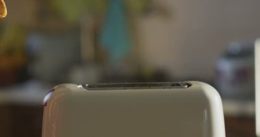 Günü kahvaltı mutfak masasının üstünde yavaş çekimde güneşli sabah kahvaltıda kızarmış ekmek ekmek hazırlama