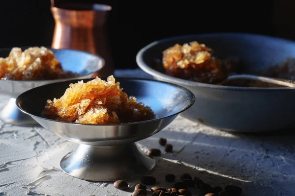 Dish for dessert with coffee ice, a bowl and a grain on the table close-up. Sicilian granite