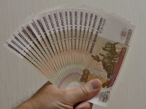 Russian banknote paper fan in hand