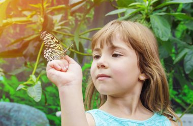 Çocuk ile bir kelebek. Seçici odak.