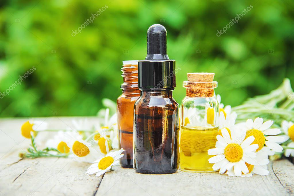 Chamomile extract in a small bottle. Selective focus. 