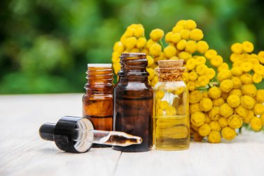 tansy medicinal extract, tincture, decoction, oil, in a small bottle nature clipart