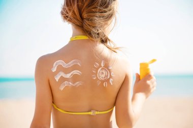 Sahildeki çocuk güneş kremi sürüyor. Seçici odaklanma. İnsanlar.