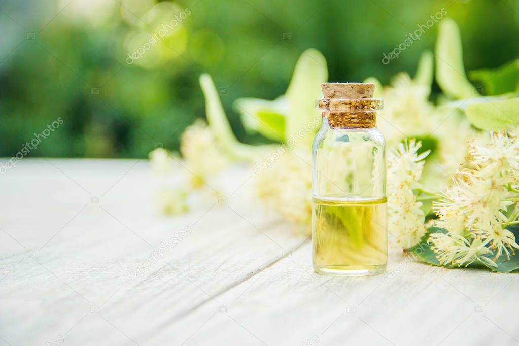 linden extract and flowers in a small bottle. Selective focus. nature.