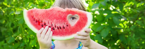 Ett barn äter vattenmelon. Selektivt fokus. Mat — Stockfoto