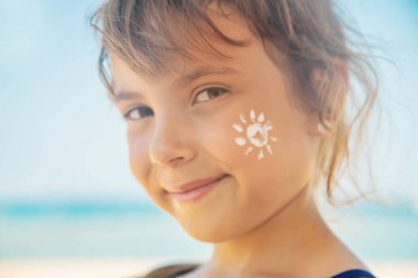 Bir çocuğun teninde güneş kremi. Seçici odak.
