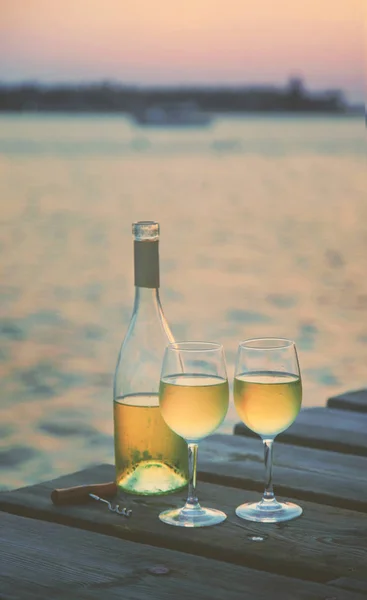 Drink wine by the sea. Selective focus.