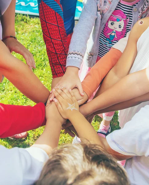 stock image children folded their hands together, play on the street. Selective focus.