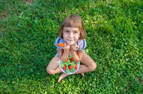 Niño come verduras brócoli y zanahorias. Enfoque selectivo . —  Fotos de Stock