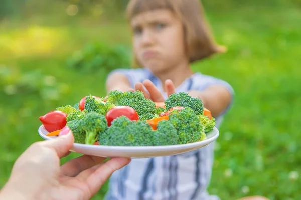 Bambino mangia broccoli di verdure e carote. Focus selettivo . — Foto Stock