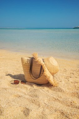Denize yakın sahilde çanta ve şapka. Seçici odaklama.