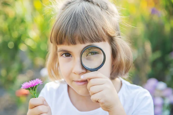 Kind mit einer Lupe in der Hand. Selektiver Fokus. — Stockfoto