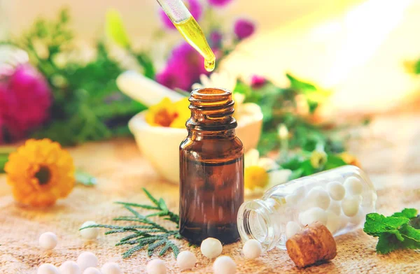 Homeopathy. Herbal extracts in small bottles. Selective focus.