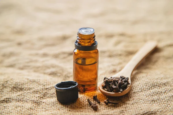 Clove essential oil in a small bottle. Selective focus. — Stock Photo, Image