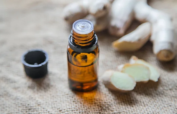 Aceite esencial de jengibre en una botella pequeña. Enfoque selectivo . — Foto de Stock