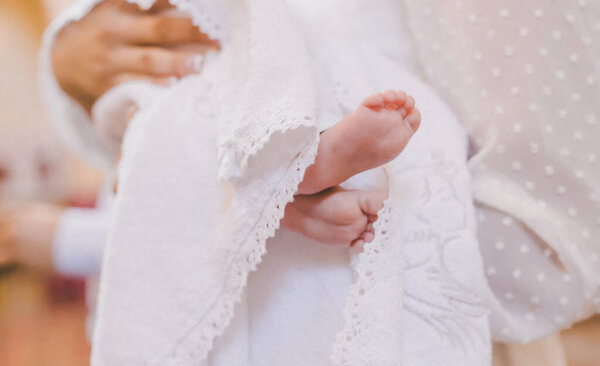 The sacrament of the baptism of a child. Selective focus. People.