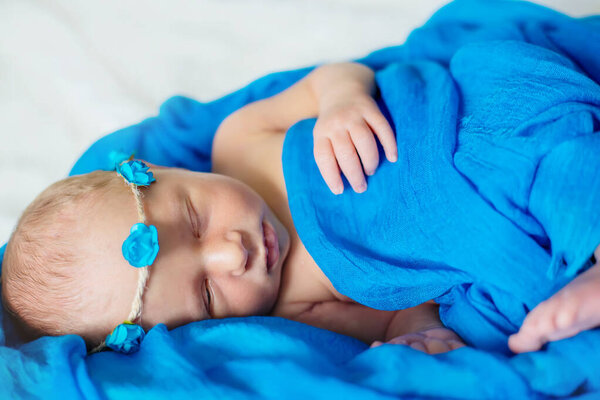 Newborn baby sleeping on a blue background. Selective focus. people.