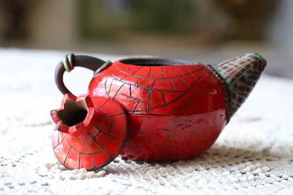 Red kettle in the form of pomegranate