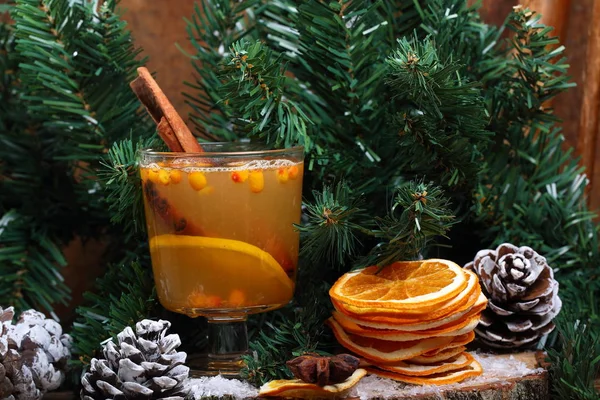 Hot drink of sea buckthorn under the Christmas tree