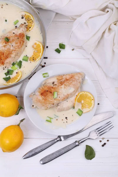 Chicken with lemons on white background
