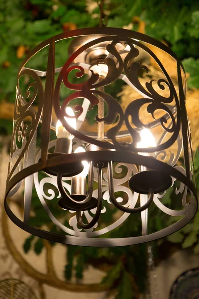 Wrought iron lampshade. Openwork forged ceiling