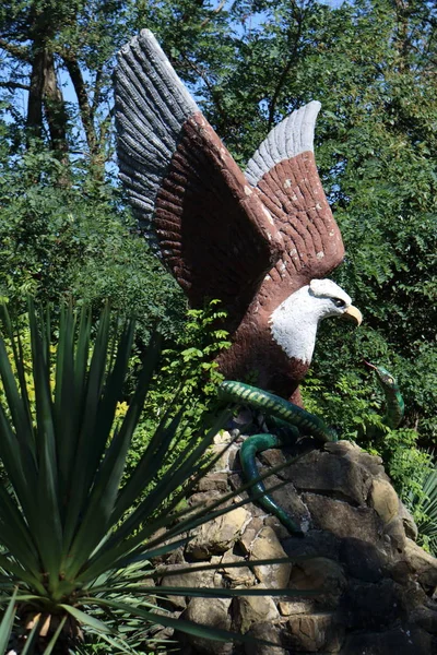 Sculpture of an eagle pecking a snake