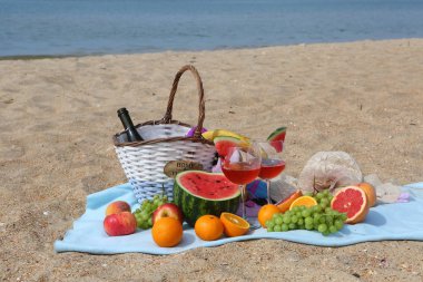 sahilde bir piknik kırmızı şarap, karpuz, üzüm ve greyfurt