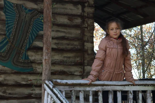 Girl on a wooden porch at home