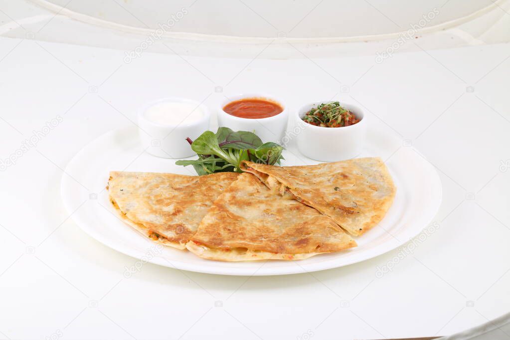 Tortillas with meat and cheese served with sauce