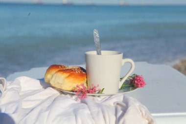 Kahvaltıda. Koyu kahve ve hamur işi.