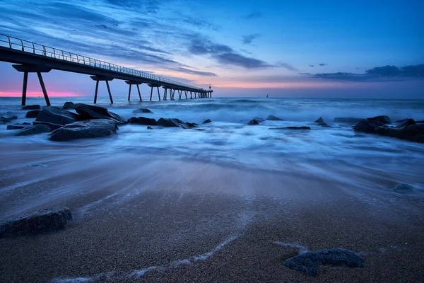 Barcelona, Badalona 'daki Petroleo köprüsünün kumsalından gün doğumu.