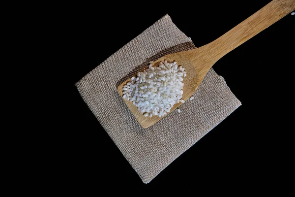 Cuchara Madera Llena Arroz Sobre Fondo Negro —  Fotos de Stock