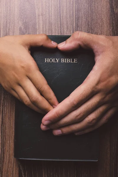 Santa Biblia con las manos en forma de corazón —  Fotos de Stock