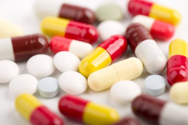 Beyaz arka plan üzerinde ilaç hapları, tabletler ve kapsüller