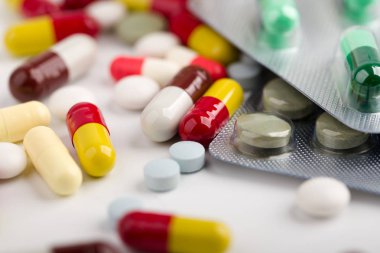 Beyaz arka plan üzerinde ilaç hapları, tabletler ve kapsüller