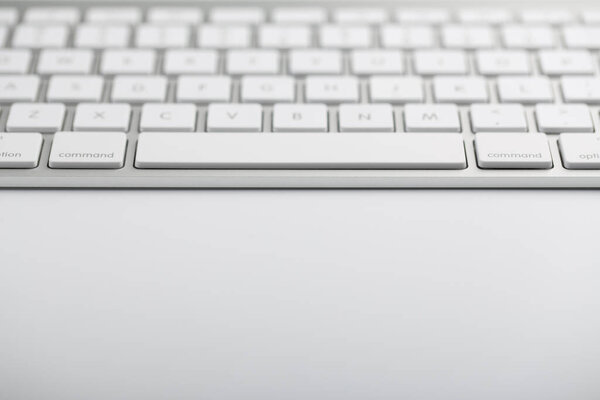 Closeup shot of white keyboard on white background.