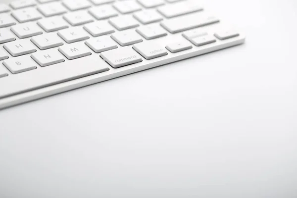 Closeup shot of white keyboard on white background.