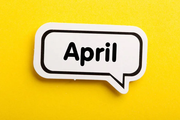 April Speech Bubble Isolated Yellow Background — Stock Photo, Image