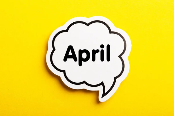 April Speech Bubble Isolated Yellow Background — Stock Photo, Image